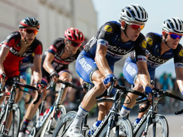 A group of cyclists racing in full cycling gear