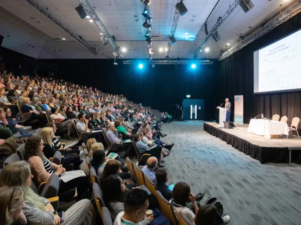 An auditorium full of people listening to a speaker at the CCLG Annual Conference