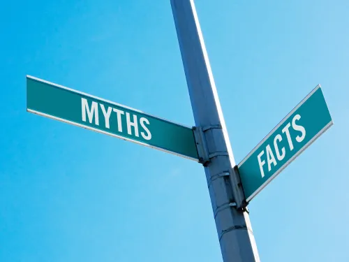 Signpost pointing in two direction, one labelled myths and the other labelled facts.