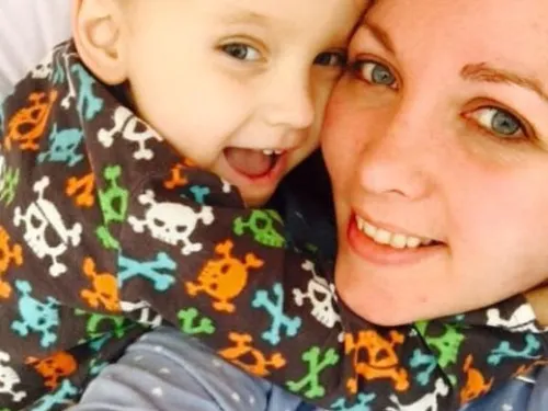 Kai and his mum hugging.